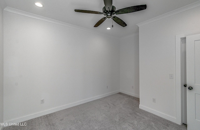 carpeted empty room with ceiling fan and ornamental molding