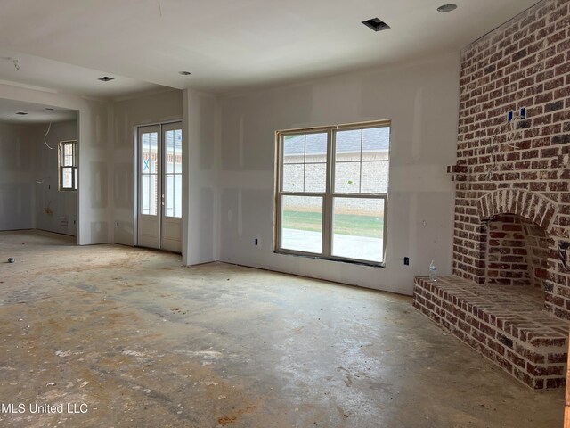 unfurnished living room with a healthy amount of sunlight