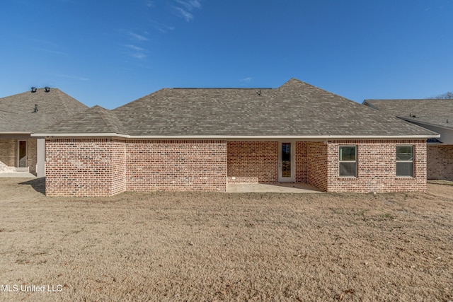 back of house featuring a patio area and a yard