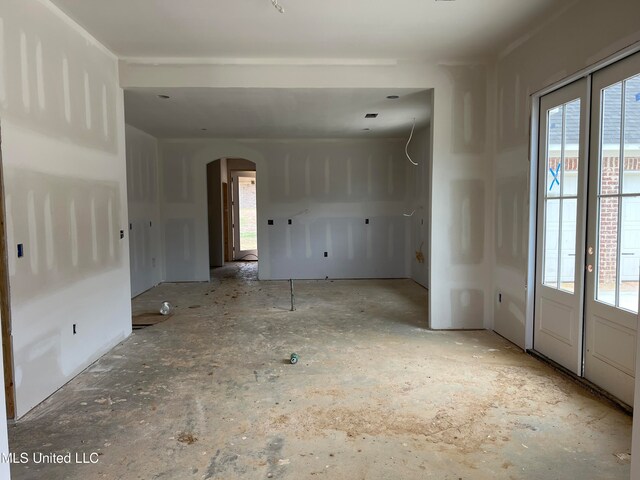 empty room featuring french doors and plenty of natural light