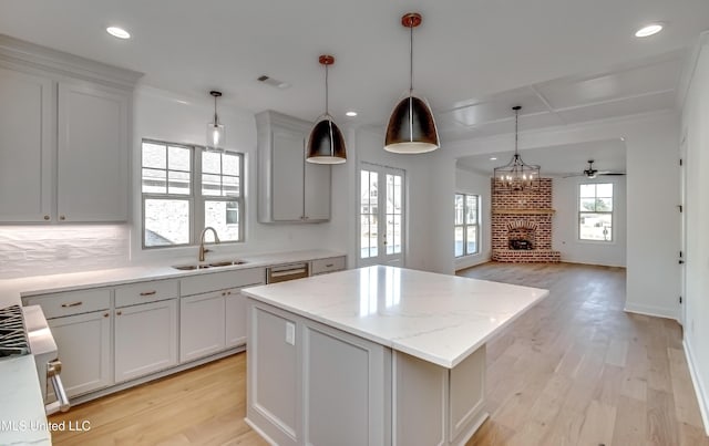 kitchen with sink, a center island, pendant lighting, and tasteful backsplash