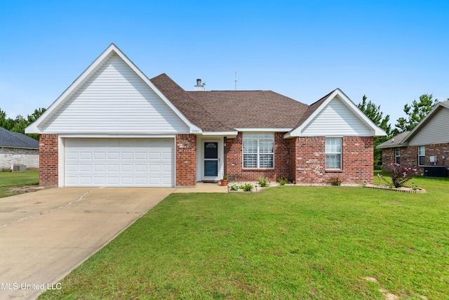 2301 Paula Cir, Ocean Springs, MS 39564 - view of front facade featuring brick siding, driveway, a front yard, a garage, and roof with shingles