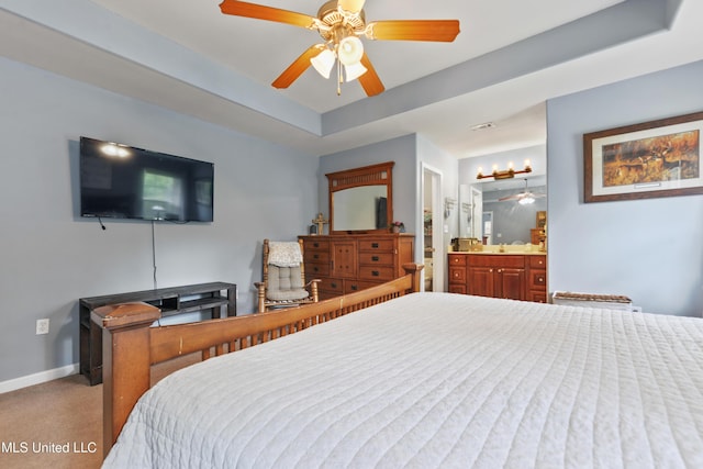 2301 Paula Cir, Ocean Springs, MS 39564 - carpeted bedroom with a raised ceiling, connected bathroom, and ceiling fan