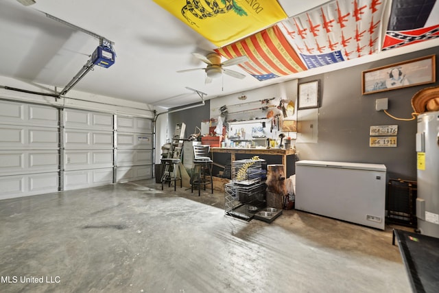 2301 Paula Cir, Ocean Springs, MS 39564 - garage featuring refrigerator, a garage door opener, a ceiling fan, water heater, and a workshop area