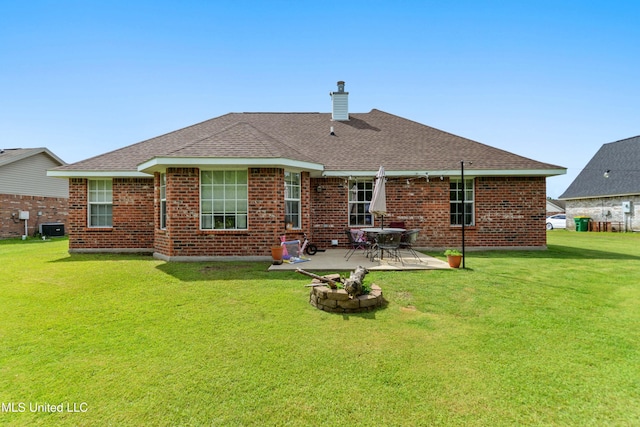 2301 Paula Cir, Ocean Springs, MS 39564 - rear view of house with a chimney, roof with shingles, a patio, and a yard