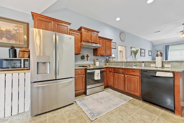 2301 Paula Cir, Ocean Springs, MS 39564 - kitchen with appliances with stainless steel finishes, under cabinet range hood, brown cabinets, light stone countertops, and a peninsula