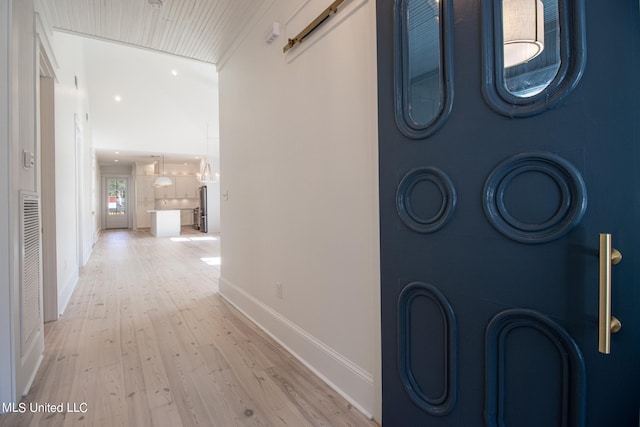 hall with hardwood / wood-style floors and a barn door