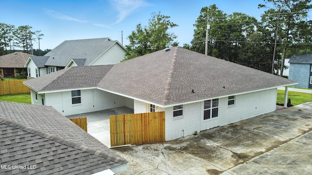 611 E E Lakeshore Dr, Carriere, MS 39426 - view of home's exterior featuring brick siding, a shingled roof, and a patio