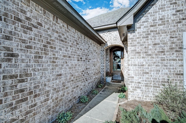 view of exterior entry with brick siding