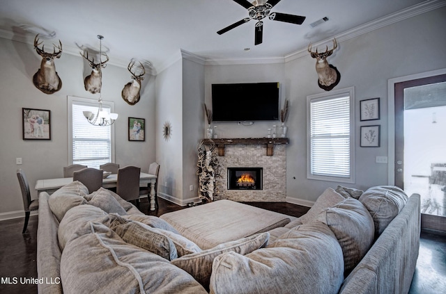 living area with visible vents, plenty of natural light, crown molding, and dark wood-type flooring