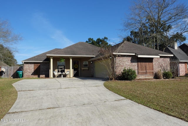 view of front of home with a garage, driveway, brick siding, and a front lawn