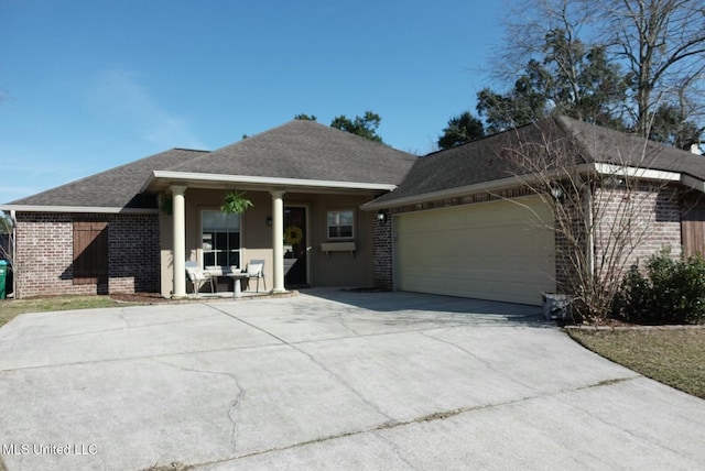 view of front of house featuring a garage, driveway, brick siding, and roof with shingles