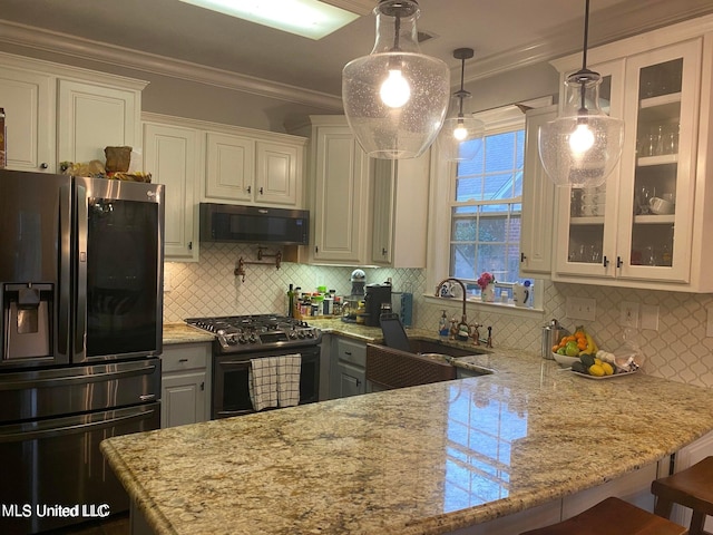 kitchen with black gas range, white cabinetry, hanging light fixtures, stainless steel refrigerator with ice dispenser, and a kitchen bar