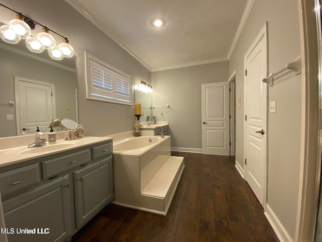 bathroom featuring vanity, wood-type flooring, a tub, and ornamental molding