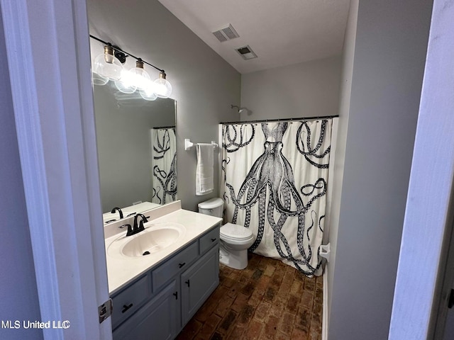 bathroom featuring a shower with curtain, vanity, and toilet