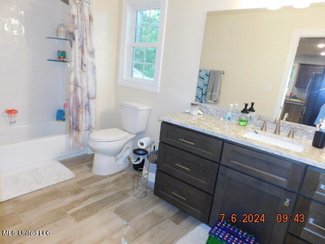 full bathroom featuring vanity, toilet, wood-type flooring, and shower / bath combo