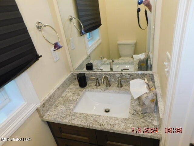 bathroom featuring vanity and toilet