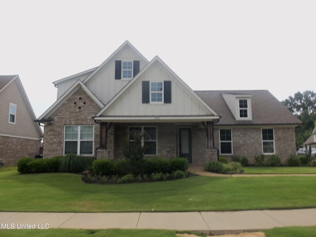 7156 Edgewater Dr, Olive Branch, MS 38654 - craftsman house with board and batten siding, a front lawn, and brick siding