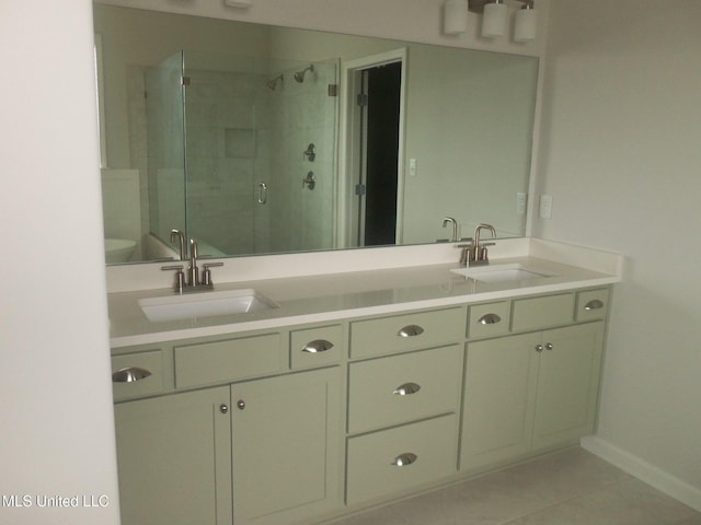 7156 Edgewater Dr, Olive Branch, MS 38654 - bathroom with double vanity, a stall shower, tile patterned floors, and baseboards