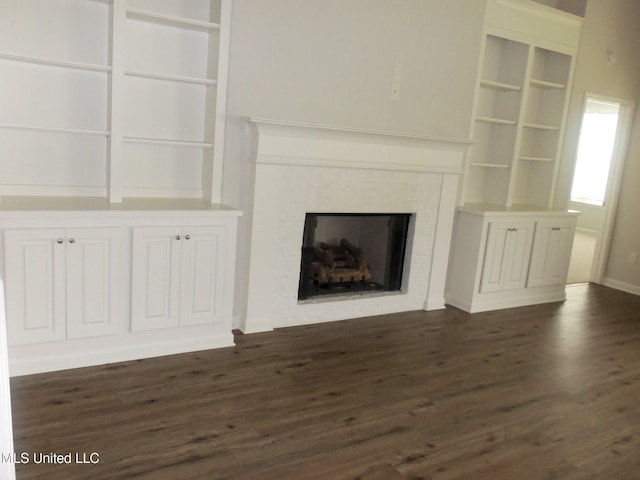 7156 Edgewater Dr, Olive Branch, MS 38654 - unfurnished living room featuring dark wood-type flooring and a fireplace