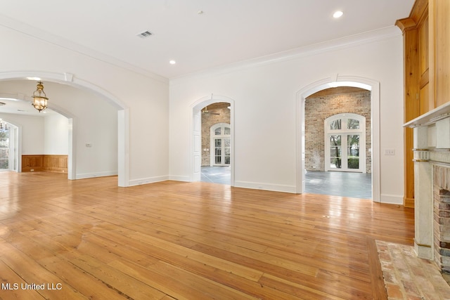 interior space with light wood-type flooring and ornamental molding