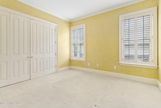 unfurnished bedroom with light colored carpet and ornamental molding