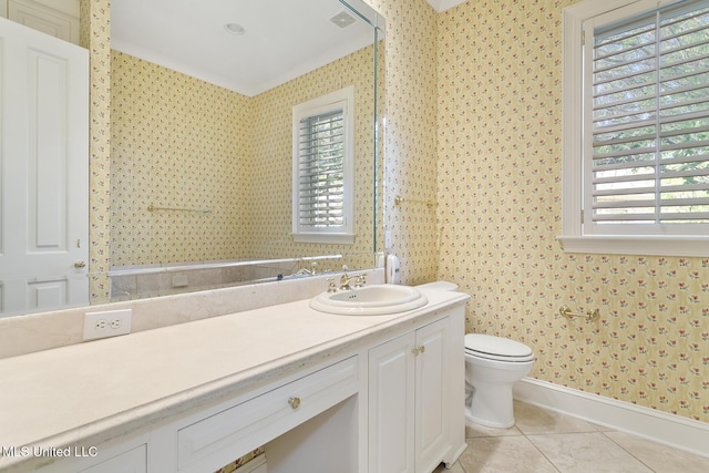 bathroom featuring tile patterned flooring, vanity, toilet, and a wealth of natural light