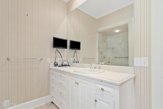 bathroom featuring a shower with door, vanity, and tile patterned flooring