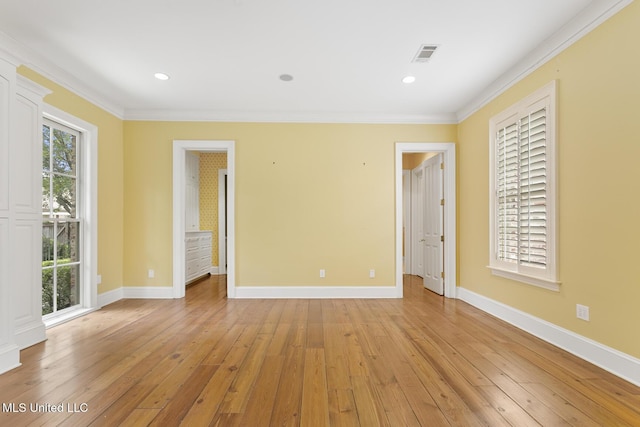 unfurnished room featuring light hardwood / wood-style floors and ornamental molding