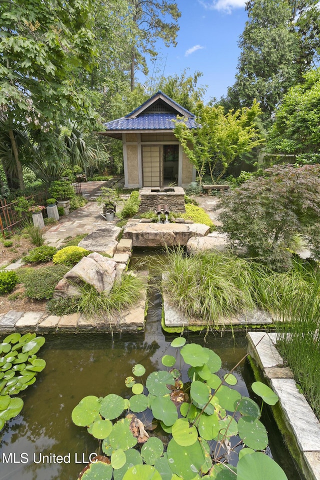 surrounding community featuring a garden pond