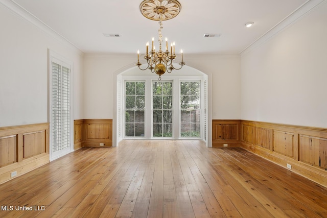 interior space with crown molding, light hardwood / wood-style flooring, and a chandelier