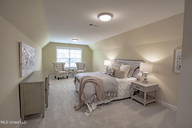 bedroom featuring light carpet and vaulted ceiling