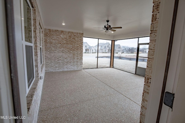 unfurnished sunroom with ceiling fan and a healthy amount of sunlight