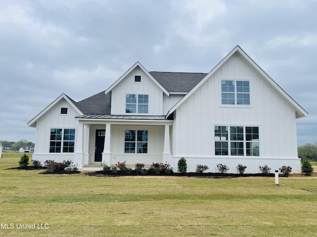 modern farmhouse with a porch and a front yard