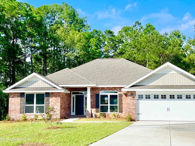 15693 Perdido Dr, Gulfport, MS 39503 - view of front of house featuring a garage, driveway, a shingled roof, and a front yard