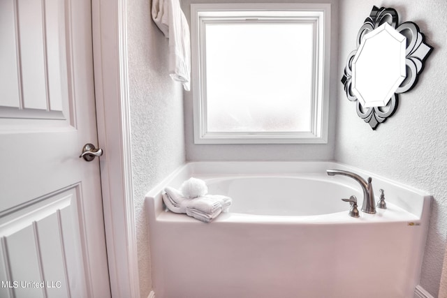 15693 Perdido Dr, Gulfport, MS 39503 - bathroom with a textured wall and a garden tub