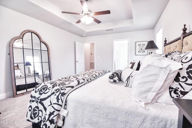 15693 Perdido Dr, Gulfport, MS 39503 - carpeted bedroom with a tray ceiling, visible vents, a ceiling fan, and baseboards