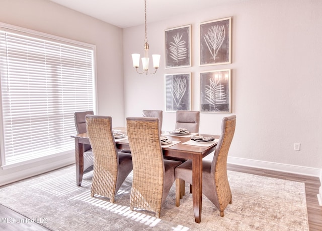 15693 Perdido Dr, Gulfport, MS 39503 - dining room with an inviting chandelier, wood finished floors, and baseboards