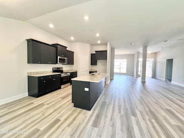15693 Perdido Dr, Gulfport, MS 39503 - kitchen with dark cabinetry, a sink, an island with sink, and appliances with stainless steel finishes