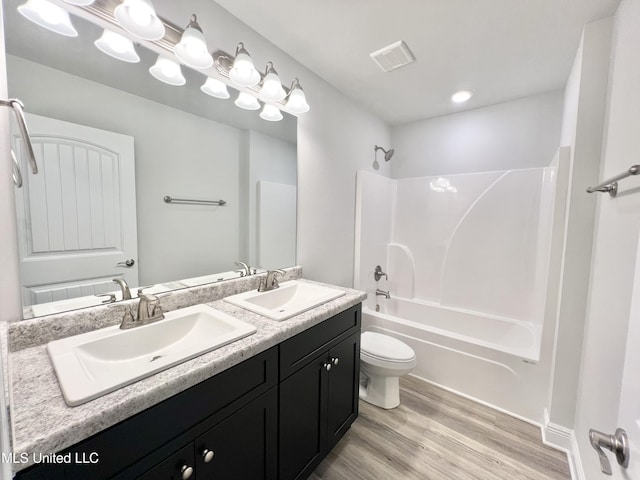 15693 Perdido Dr, Gulfport, MS 39503 - full bath with shower / tub combination, wood finished floors, a sink, and visible vents