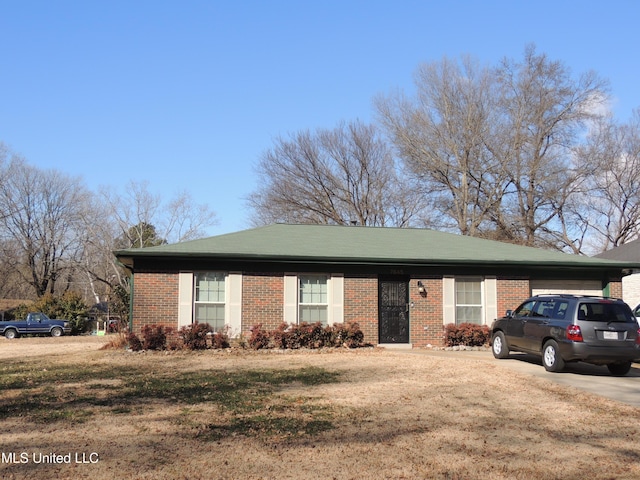 ranch-style house with a front lawn and a carport