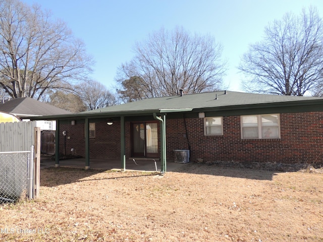 rear view of property with central AC and a patio