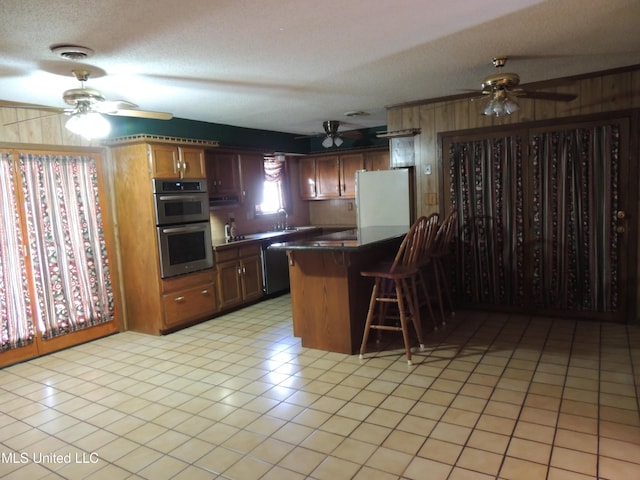 kitchen with kitchen peninsula, black dishwasher, a textured ceiling, stainless steel double oven, and white refrigerator