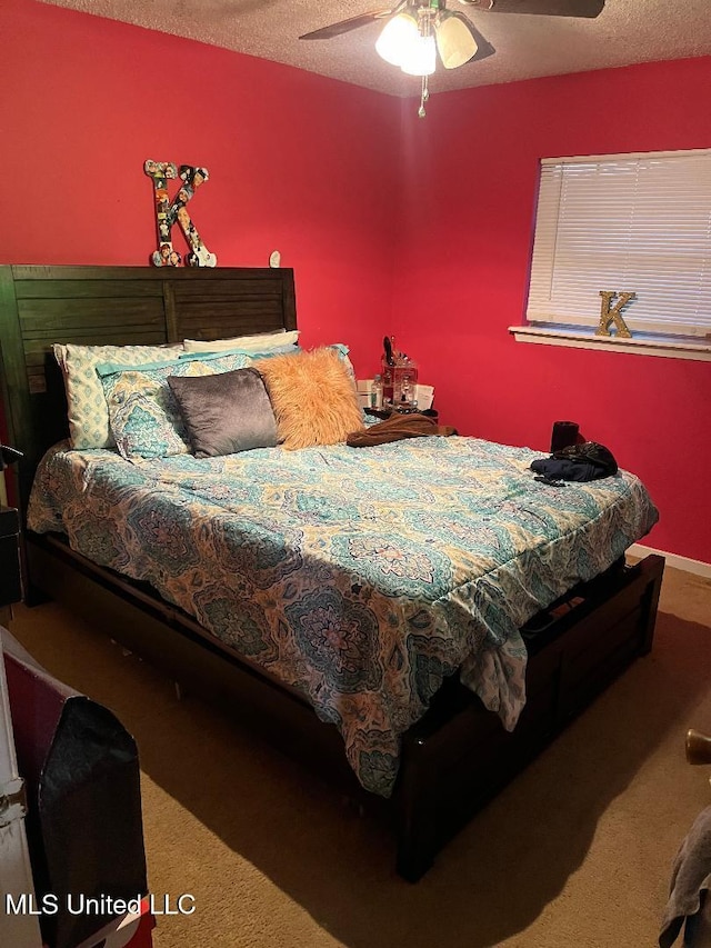 carpeted bedroom with a textured ceiling and ceiling fan