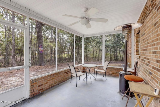 sunroom featuring plenty of natural light and a ceiling fan