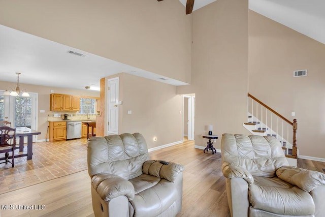 living area with light wood-type flooring and visible vents