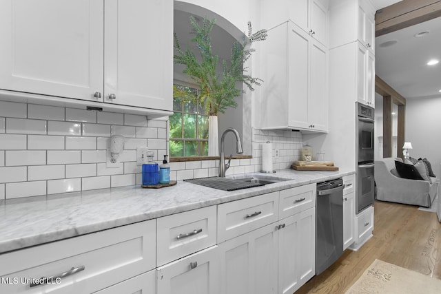 3844 Hawthorn Dr, Jackson, MS 39216 - kitchen with white cabinetry, light wood-style floors, appliances with stainless steel finishes, and a sink