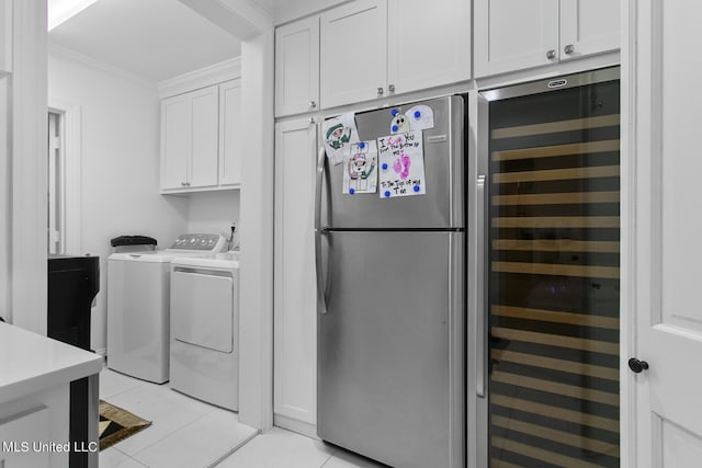 3844 Hawthorn Dr, Jackson, MS 39216 - washroom with cabinet space, wine cooler, ornamental molding, washing machine and clothes dryer, and light tile patterned floors