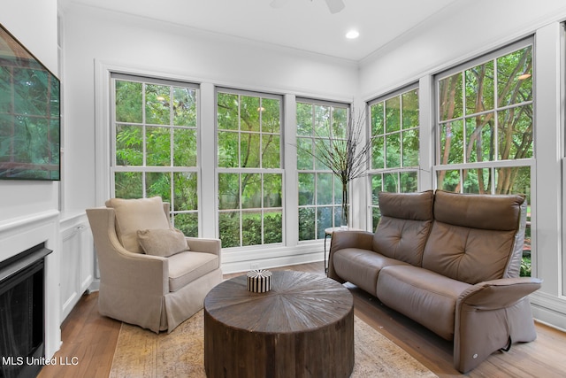 sunroom / solarium featuring ceiling fan