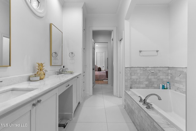 bathroom with vanity, tiled bath, crown molding, and tile patterned flooring